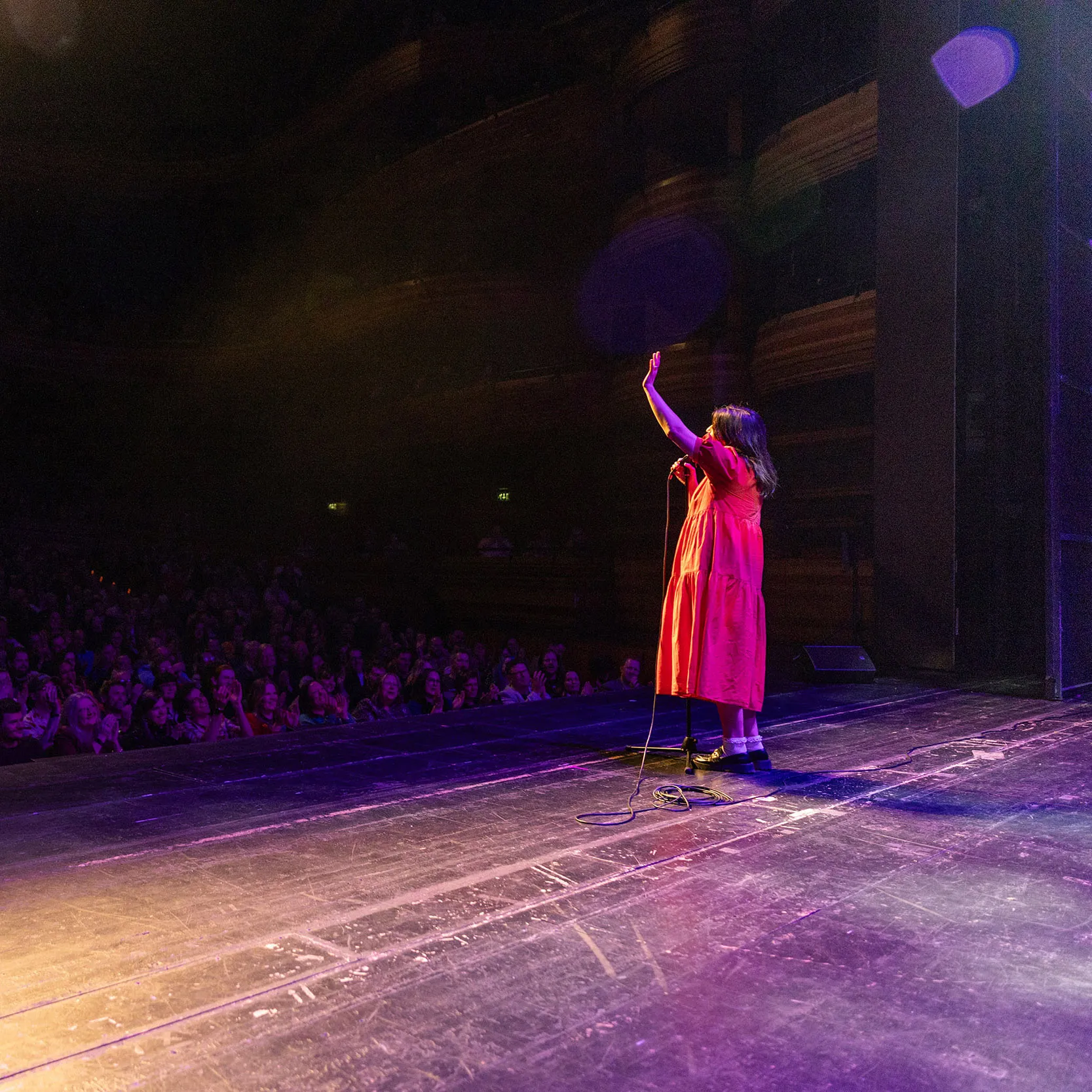 A stand up comedian interacting with the audience on the Komedia Comedy Club stage