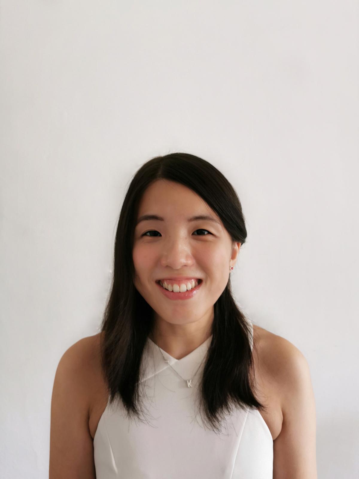 Image of Karyn, a finance professional, and Treasurer for K9 Assistance, in a white office dress.