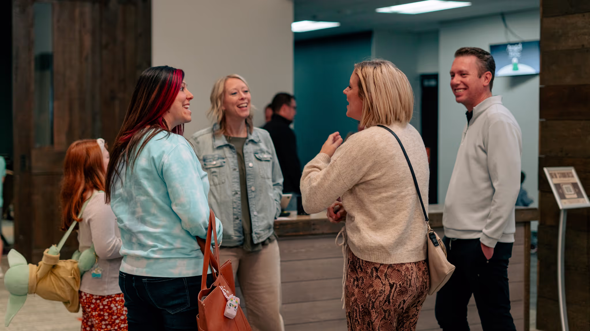 groups of people smiling and talking in the commons