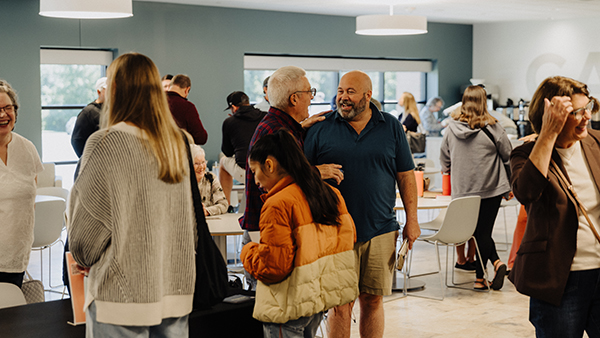 a crowd of people gathering in the church cafe