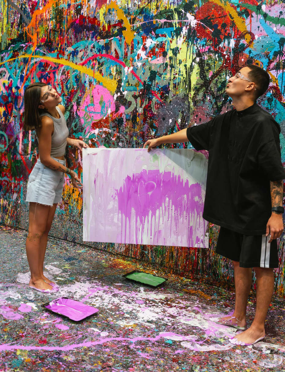 Couple presenting a pink heart canvas they created together