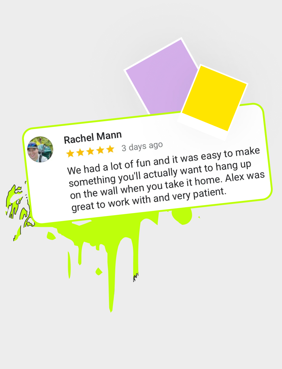 Laughing guest experimenting with the paint machine during a class