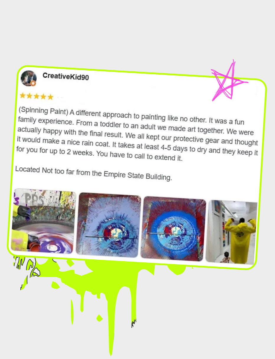 Artist in a yellow poncho aiming paint at the spinning canvas