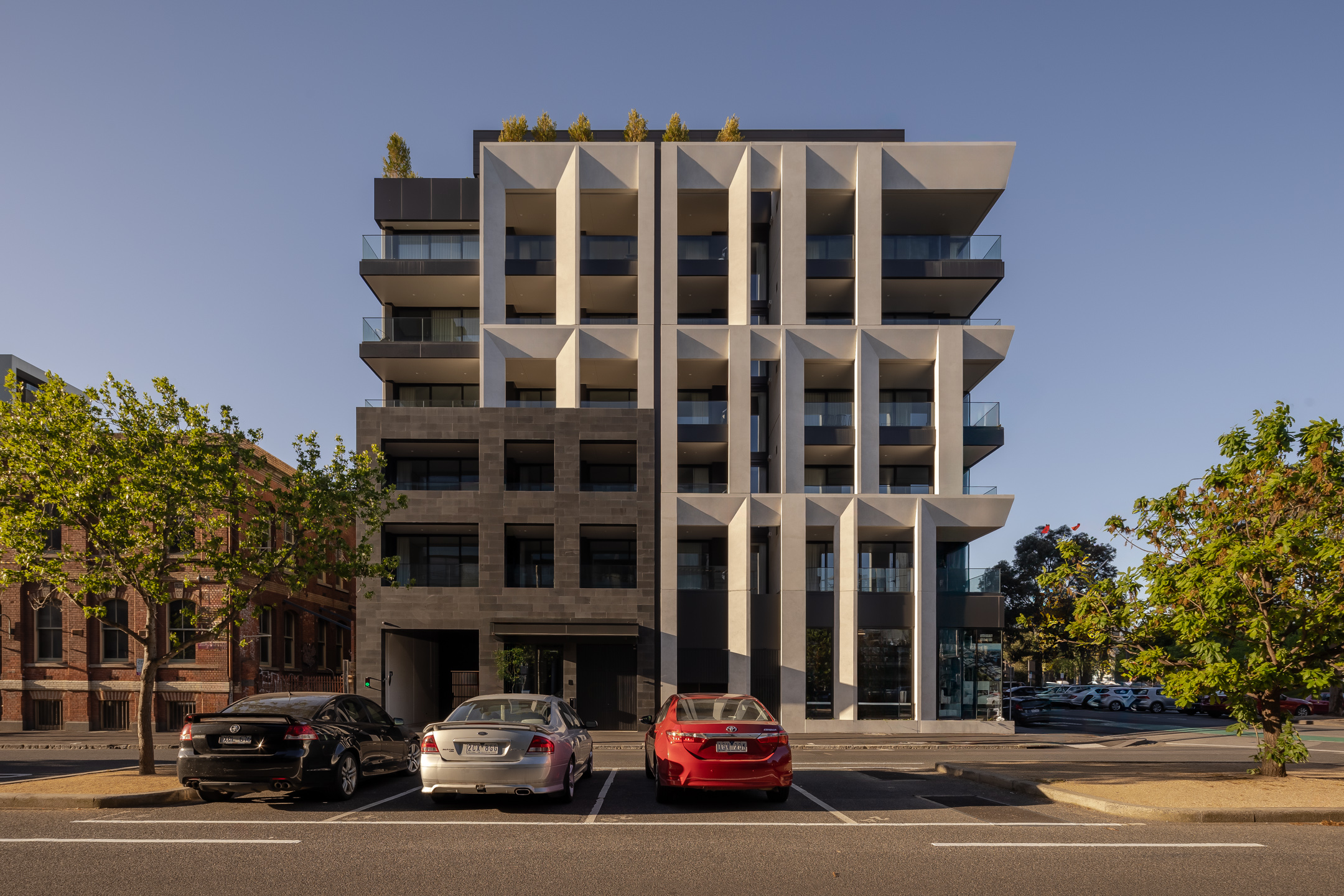 A multi-storey residential building with a geometric facade, including large balconies.