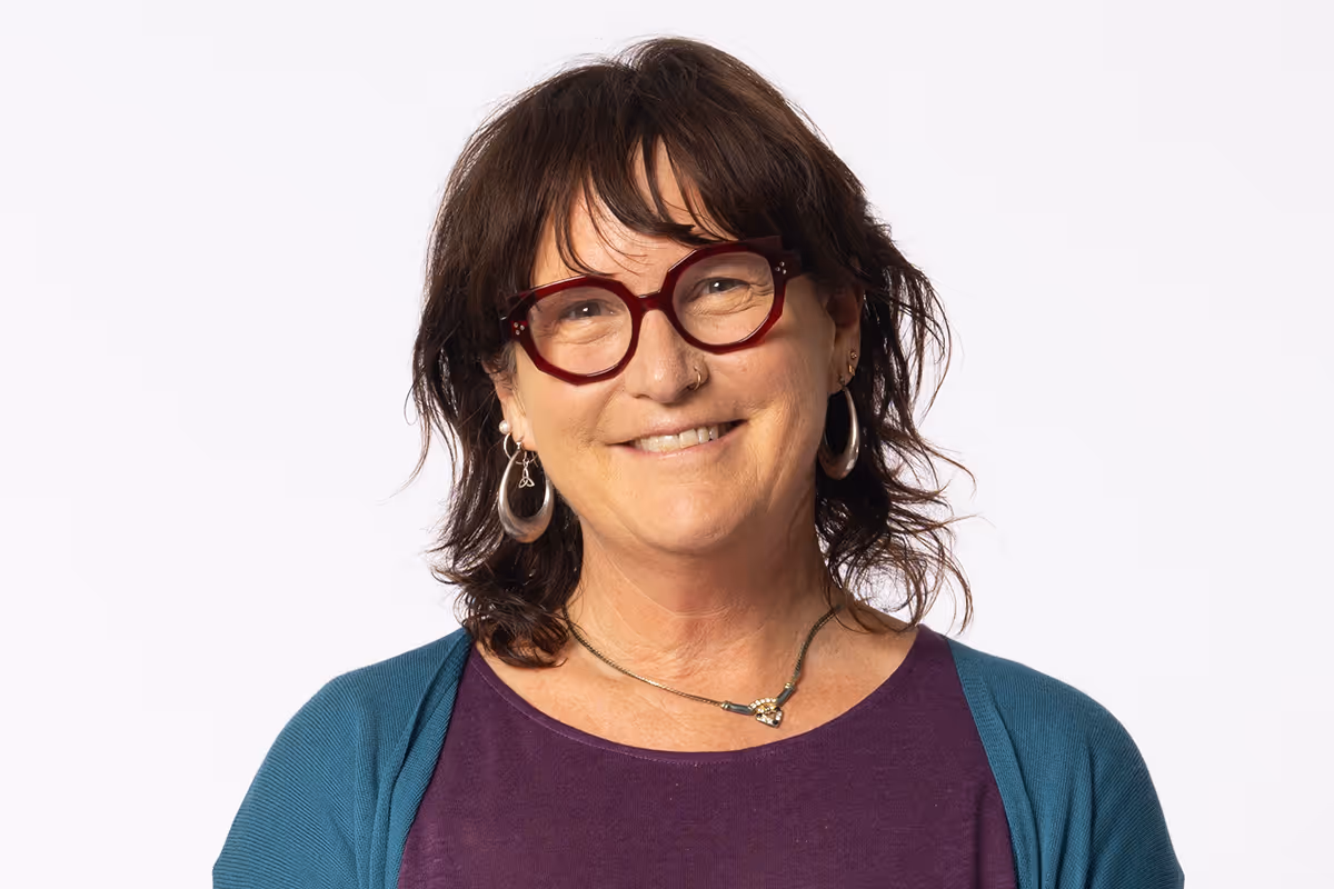 Mishe Schemmann, Creative Director, smiling portrait photograph.