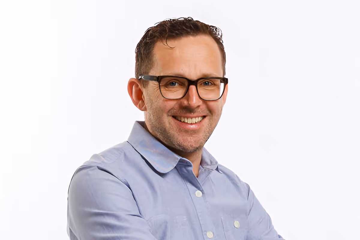 Phil Nuenlist, Event Producer, smiling portrait photograph.