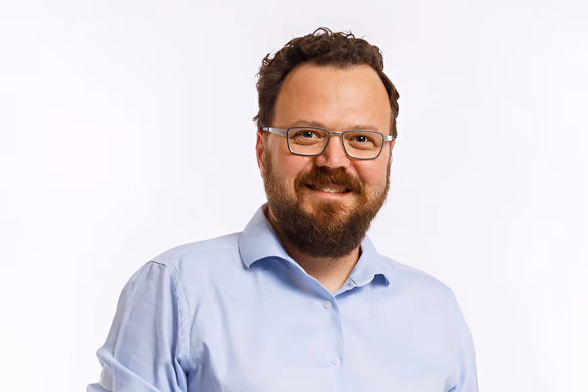 Sebastian Harnack, Video Producer, smiling portrait photograph.