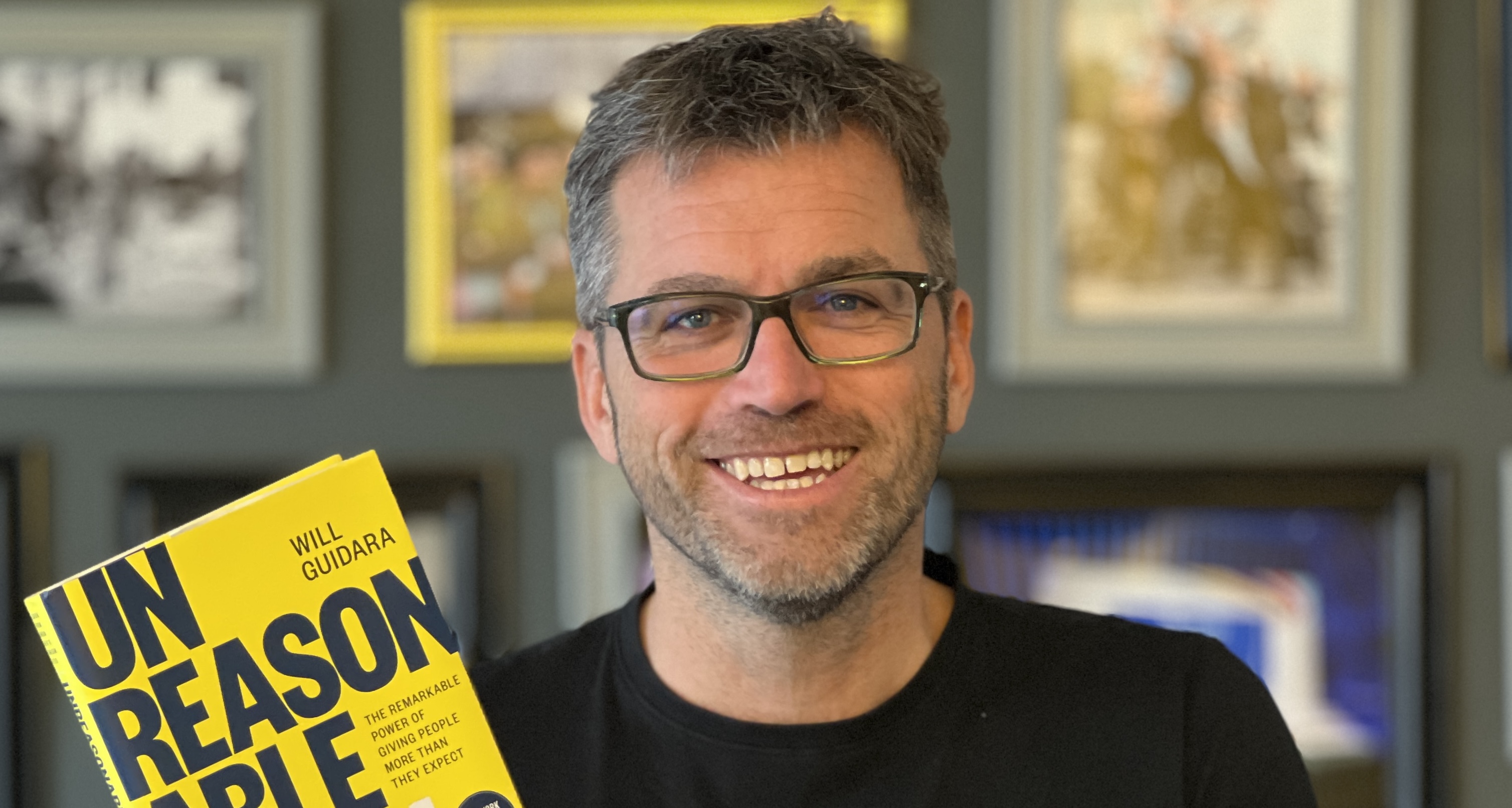 Juergen Kuenkel, Managing Partner, holds up a copy of one of his favourite books, Unreasonable Hospitality, written by a fine-dining leader, Will Guidara.