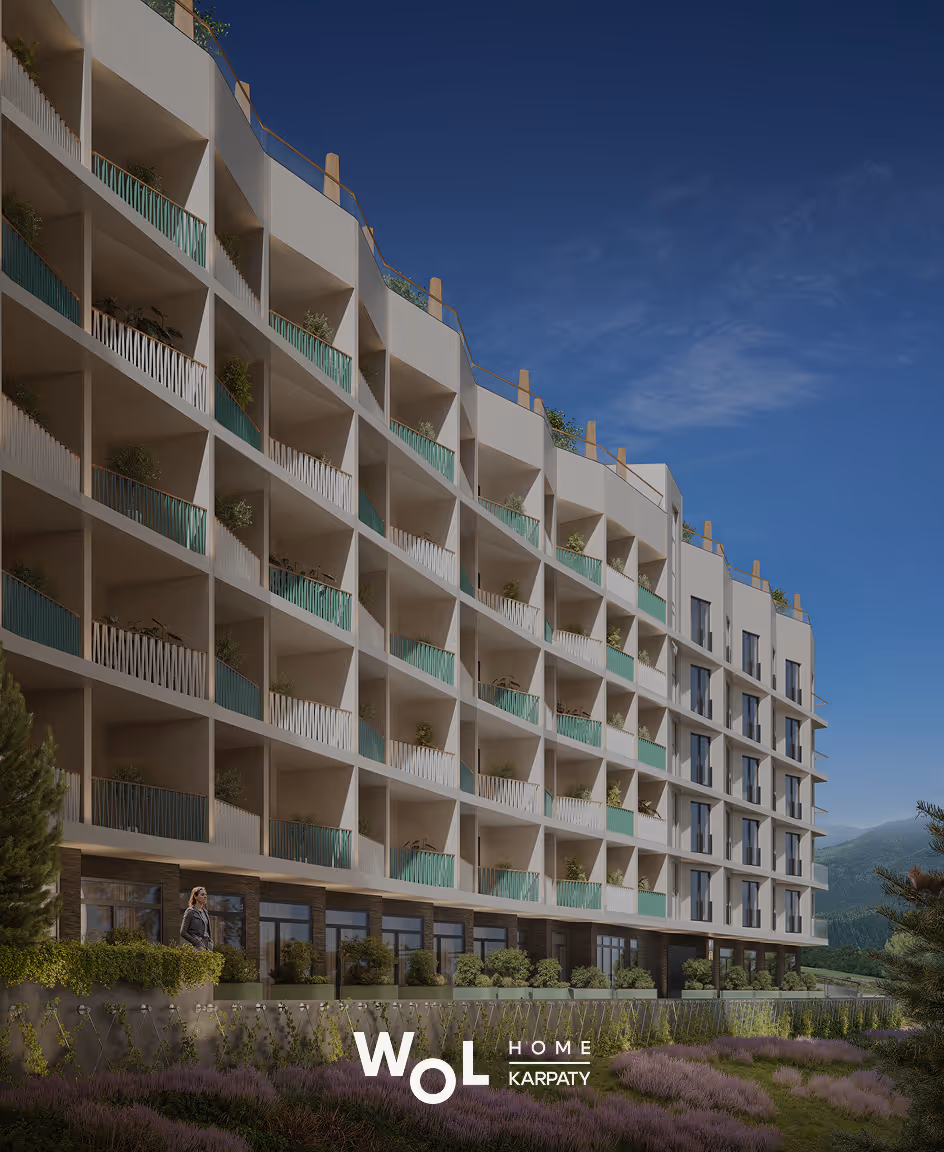 Сучасний багатоповерховий житловий будинок з балконами серед природного ландшафту на тлі гір і синього неба.