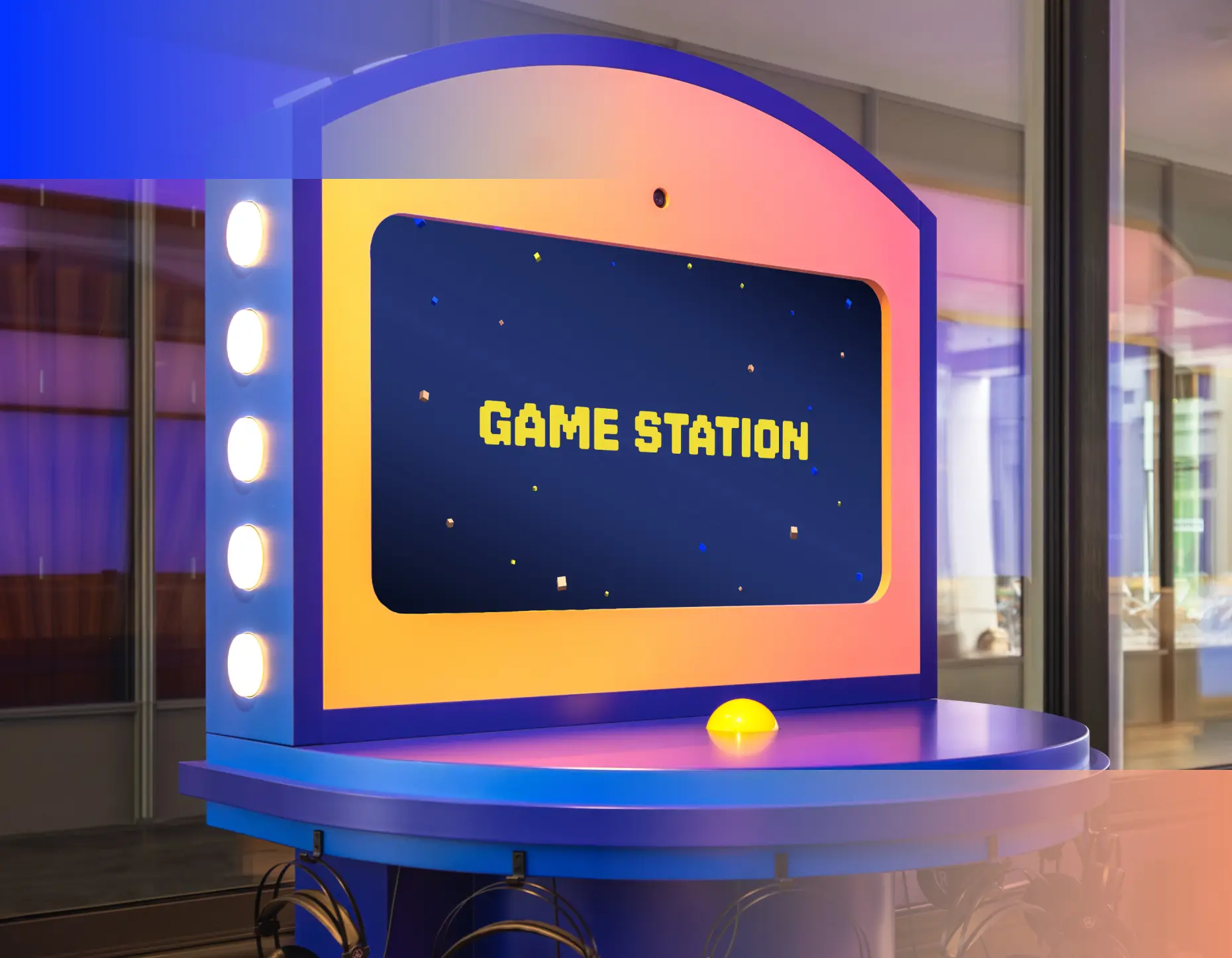 Die Game Station im Empfangsbereich: Bildschirm mit Foto-Kamera, Buzzer und Kopfhörer-Ablage – Start- und Endpunkt jeder Tour.