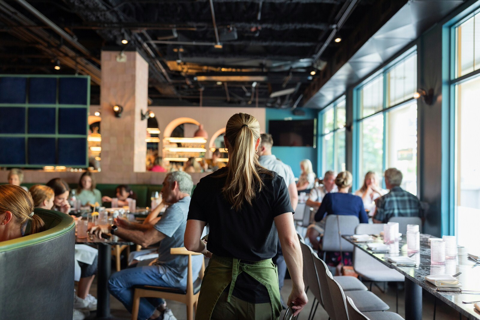 Deskless worker waiting tables in a busy restaurant