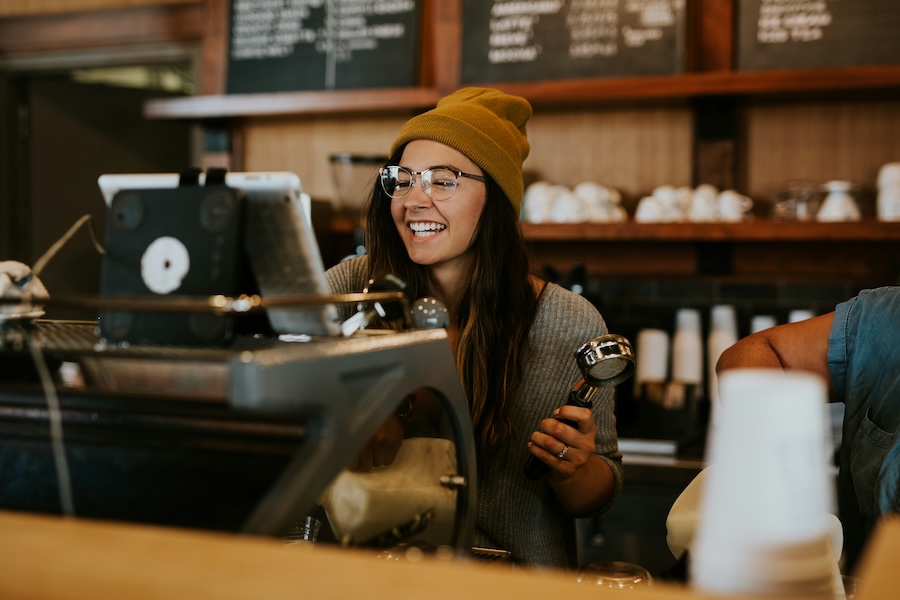 Cafe worker making coffees on her shift