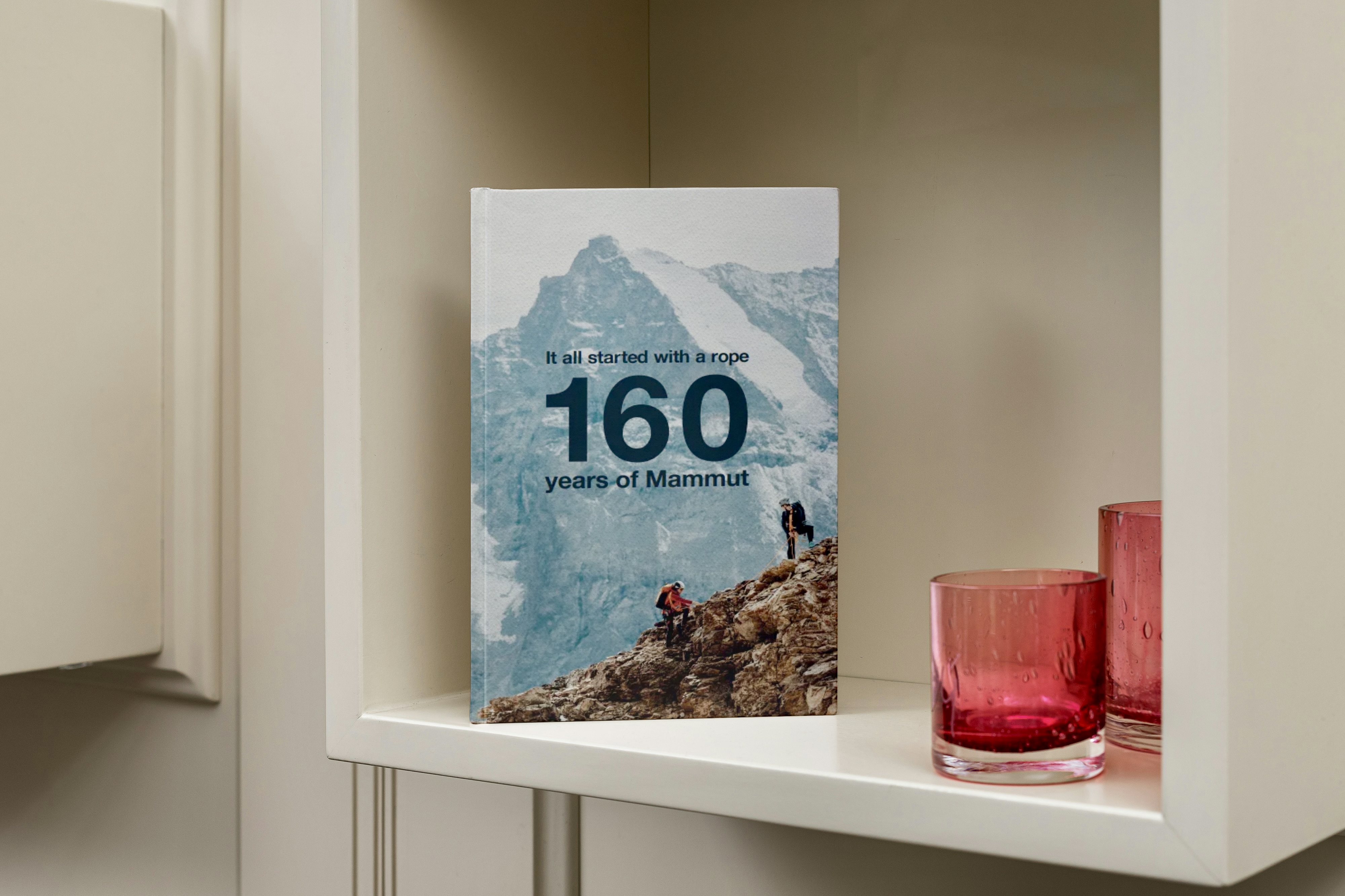 StoryTerrace - Books That Matter - Book cover: "160 years of Mammut," featuring a snowy mountain and climbers.