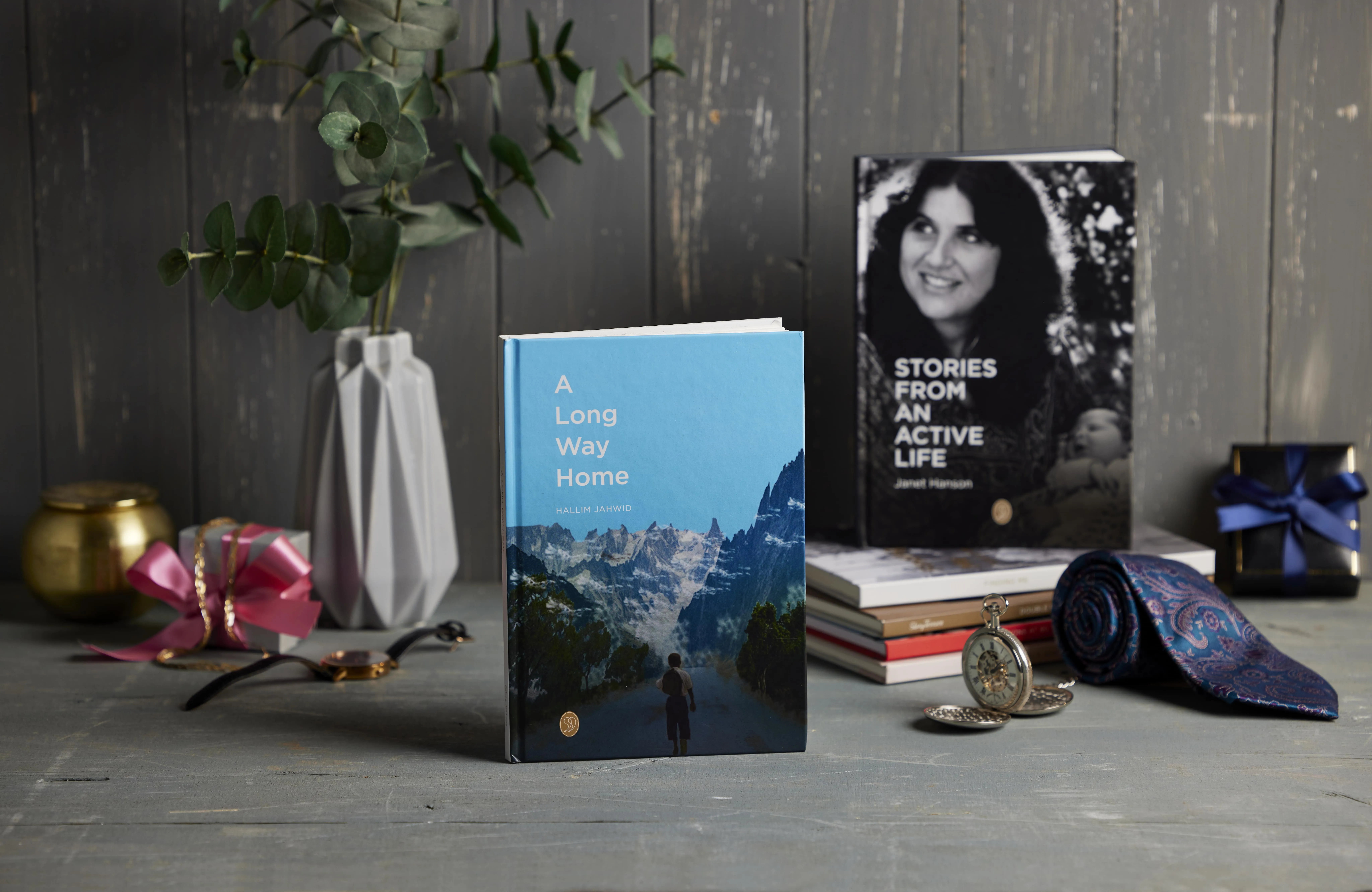 StoryTerrace - Books That Matter - Two books, "A Long Way Home" and "Stories From An Active Life," with gifts.