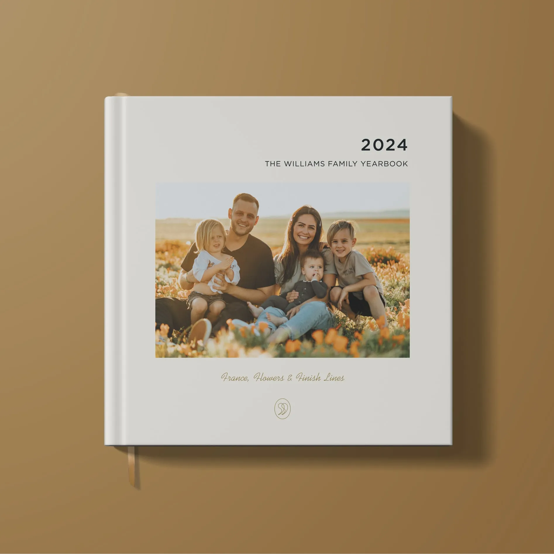 StoryTerrace - Books That Matter - 2024 Williams family yearbook cover featuring a smiling family of five sitting in a flower field at sunset.