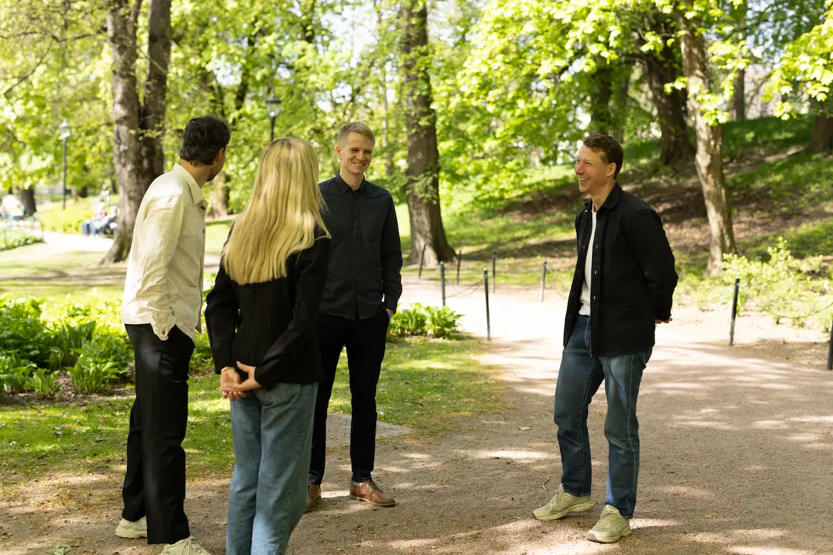 B64 team talking in a park on a sunny day