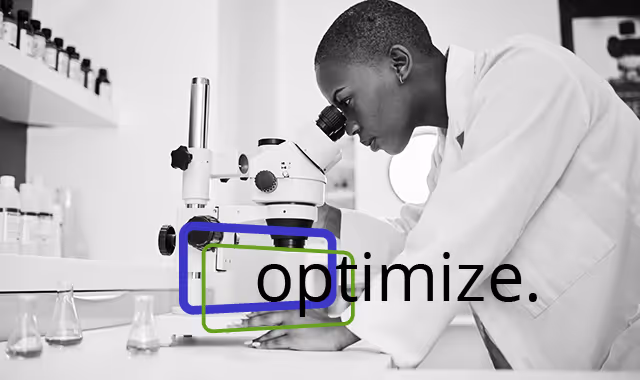 Woman in laboratory looking through a microscope