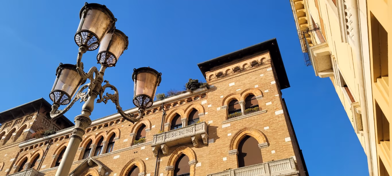 A Venetian style building put infront of a bright blue sky