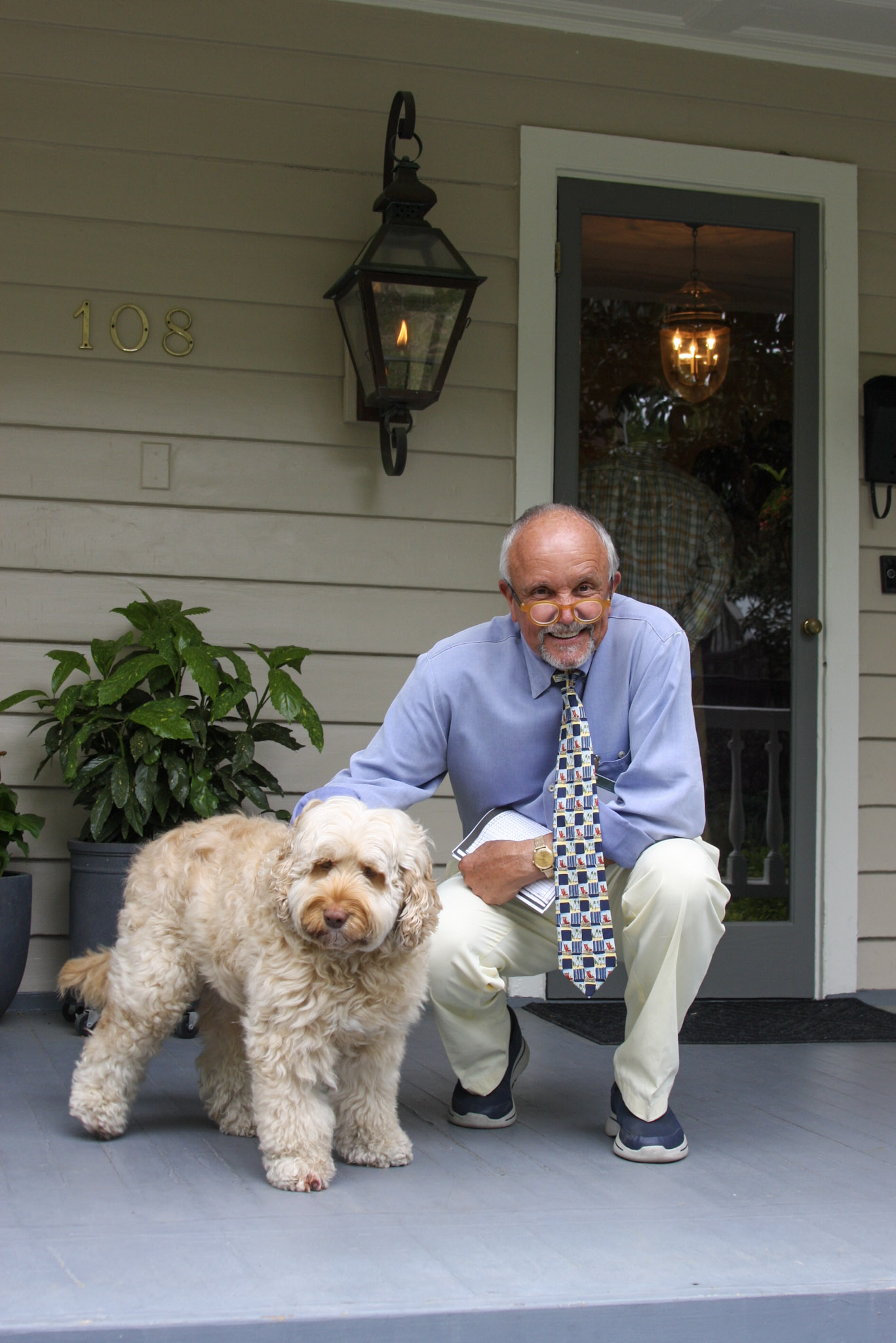 Man on porch with his dog