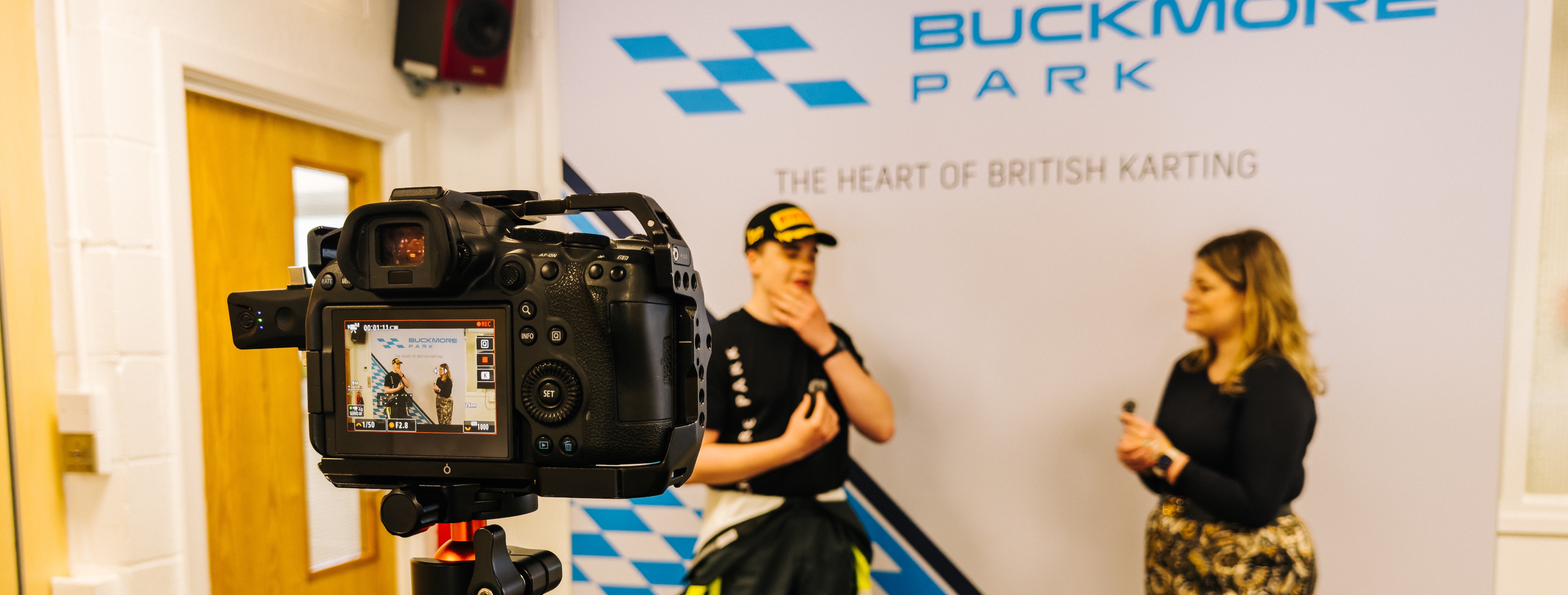 Driver is being interviewed on camera during a media training session