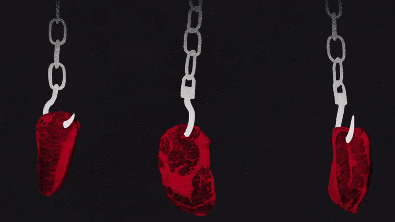Three pieces of red meat, each with a small white hook, hanging on with chains.