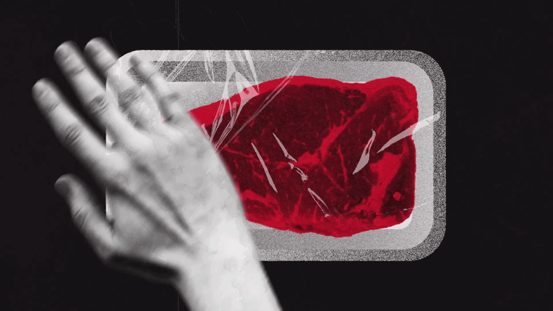 Hand slaps a packaged raw piece of special meat on a black surface.