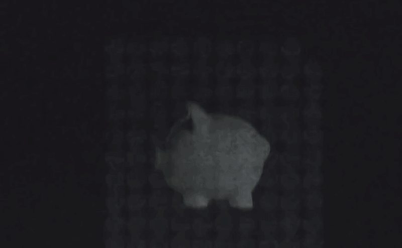 Animated piggy bank on a dark background with coins falling into its slot.