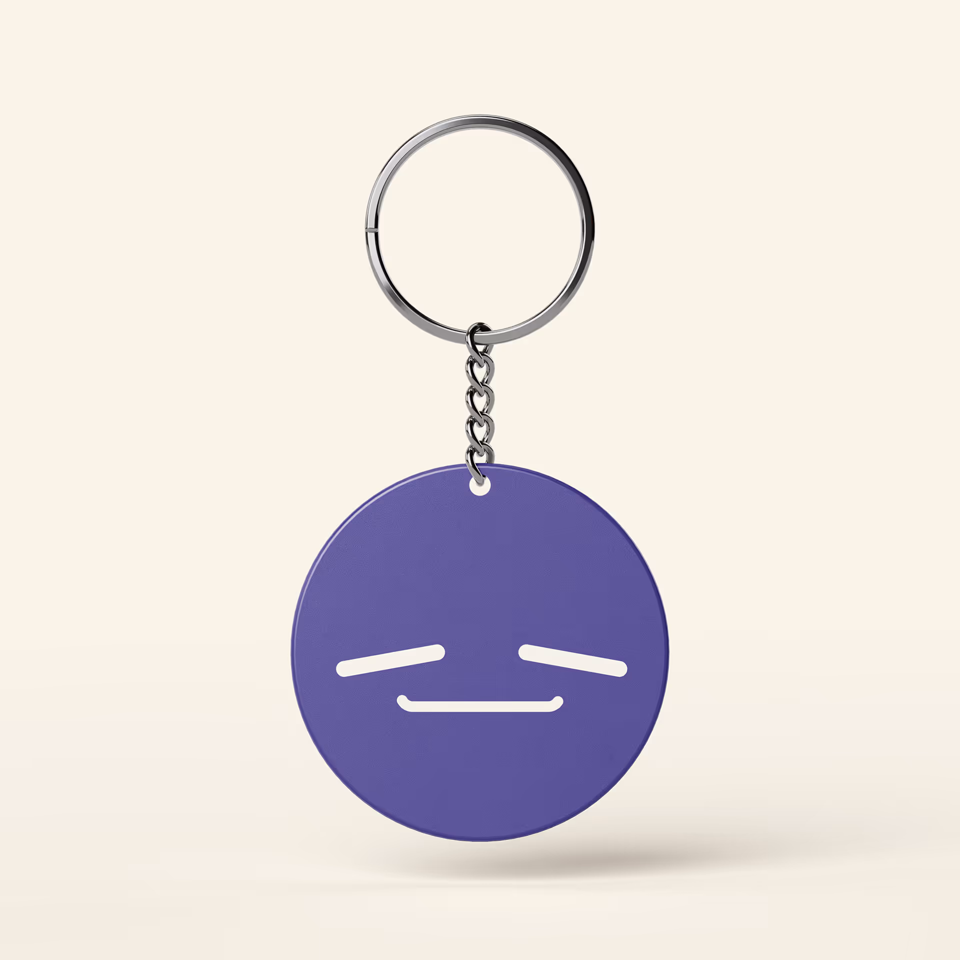 Purple round keychain with a tired or sleepy white face emoji on a light background.