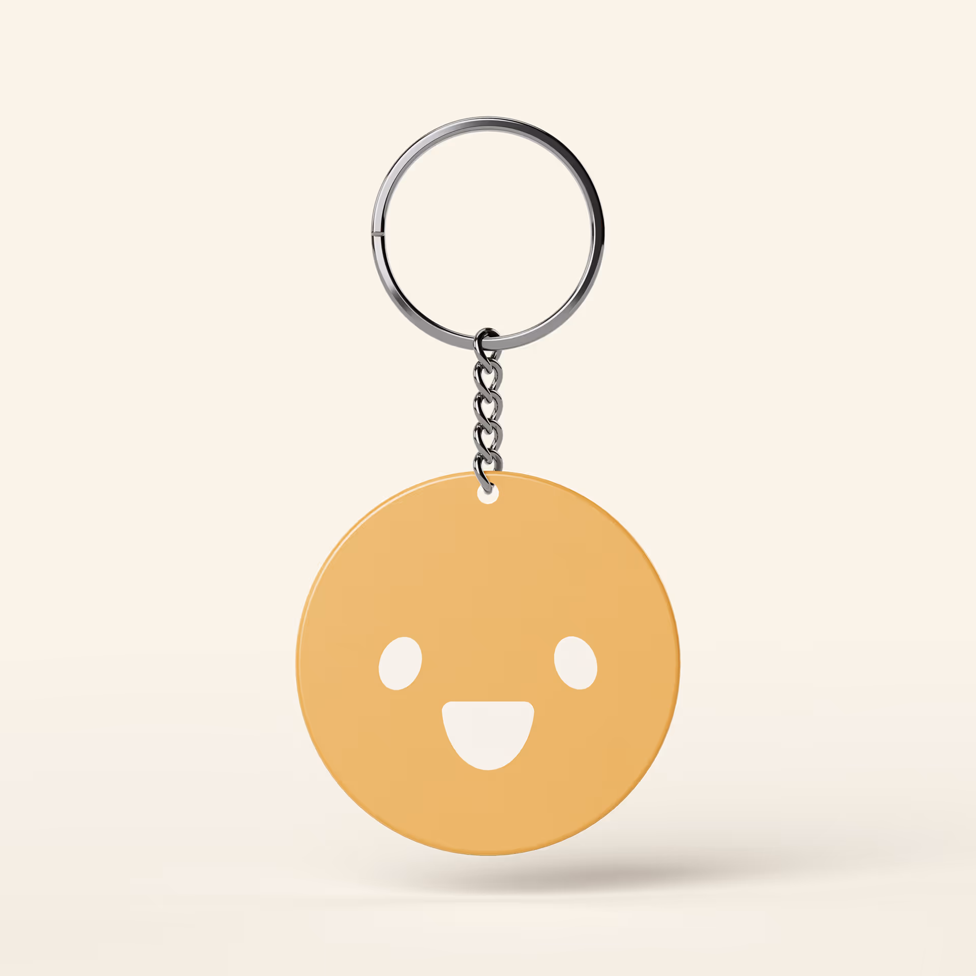 Round yellow smiley face keychain against a light background.