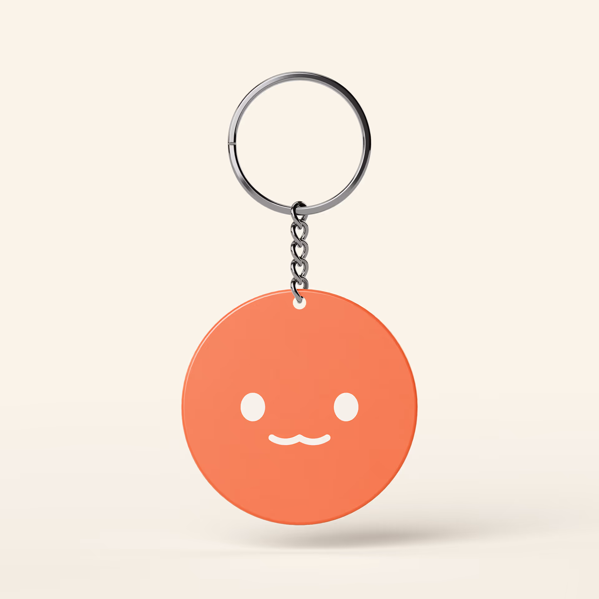 Orange round keychain with a cute smiling face and white eyes on a neutral background.