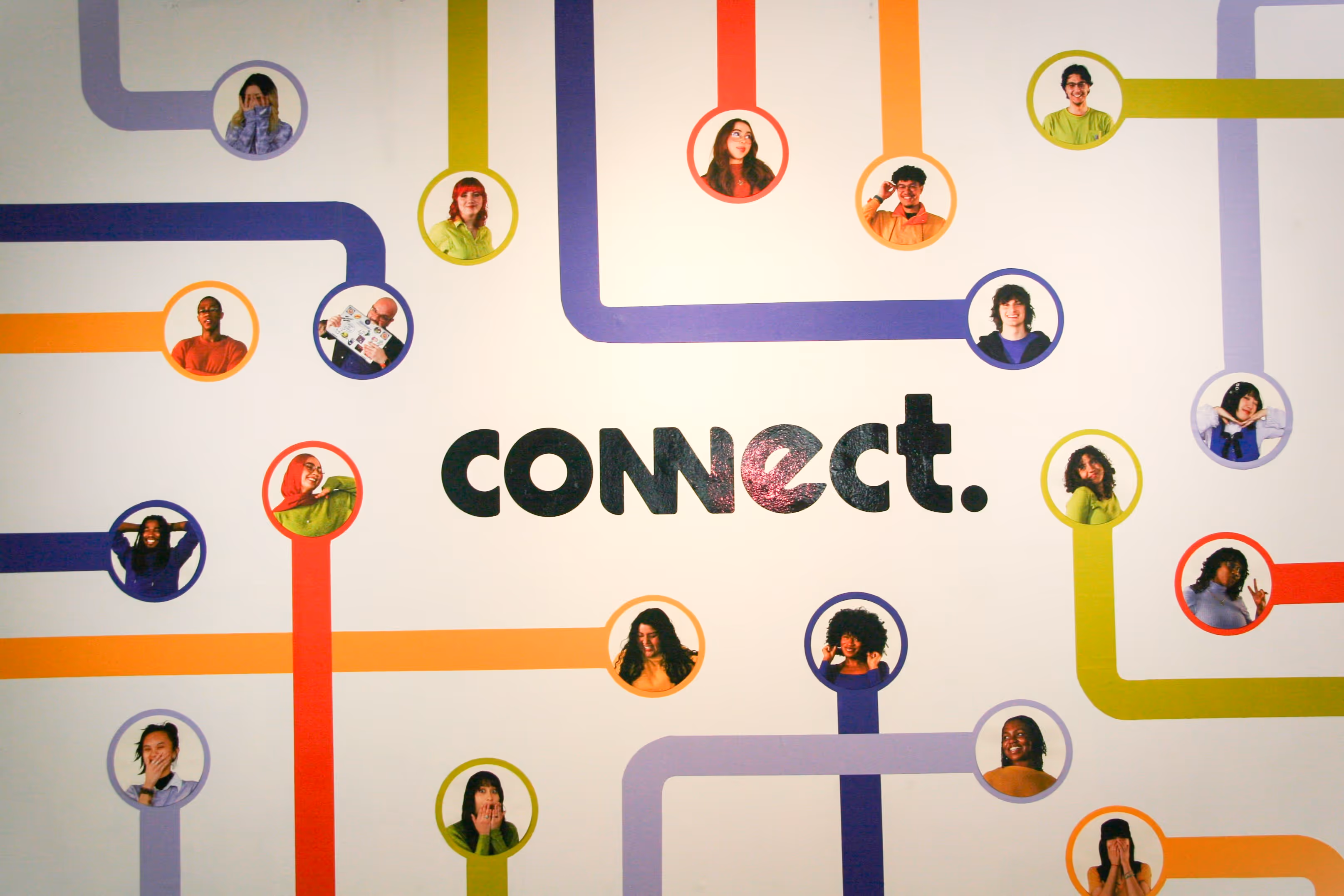 Wall graphic of diverse people connected by colorful lines around the word 'connect.'