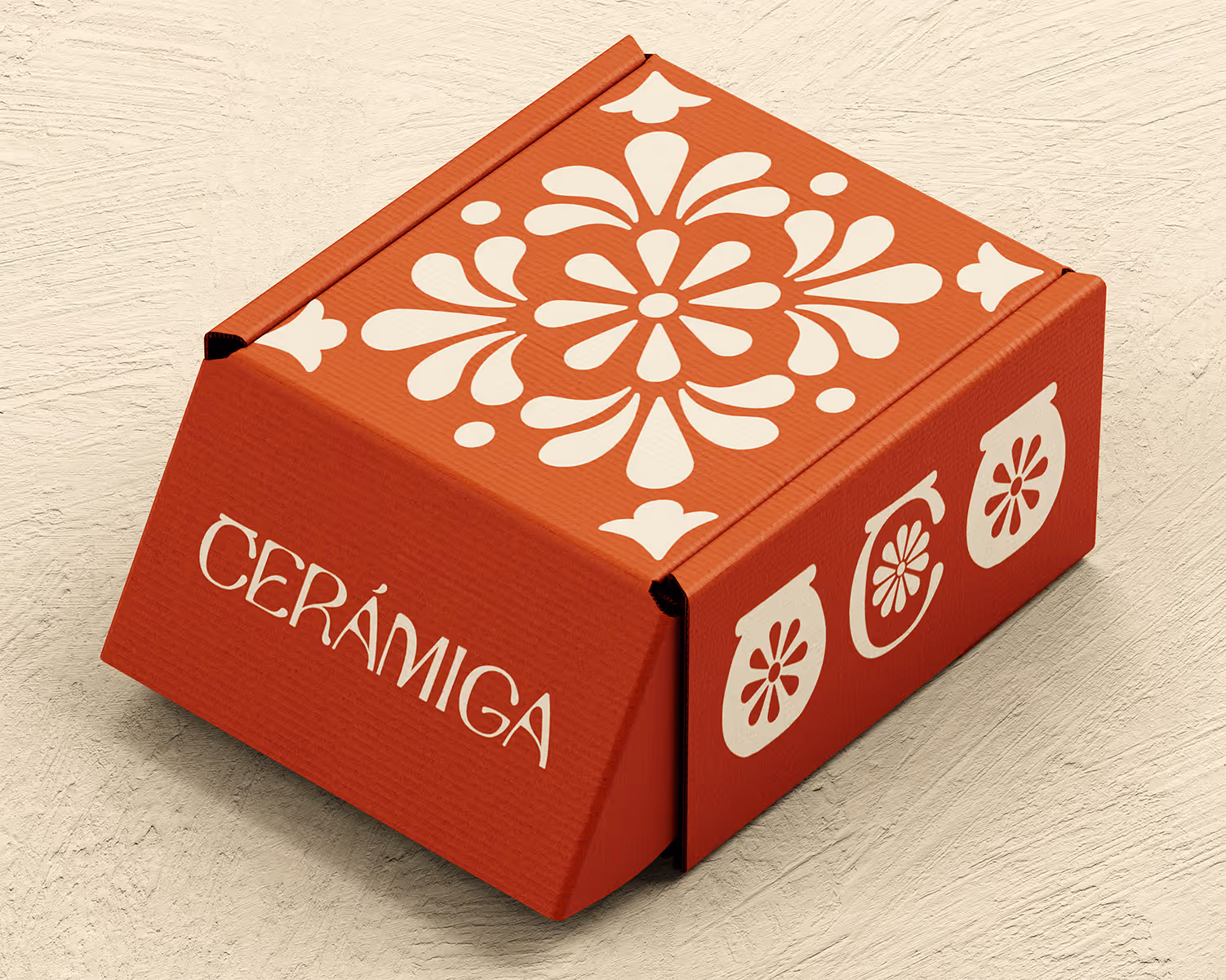 Red square box with white floral patterns and the word 'CERÁMIGA' on the front.