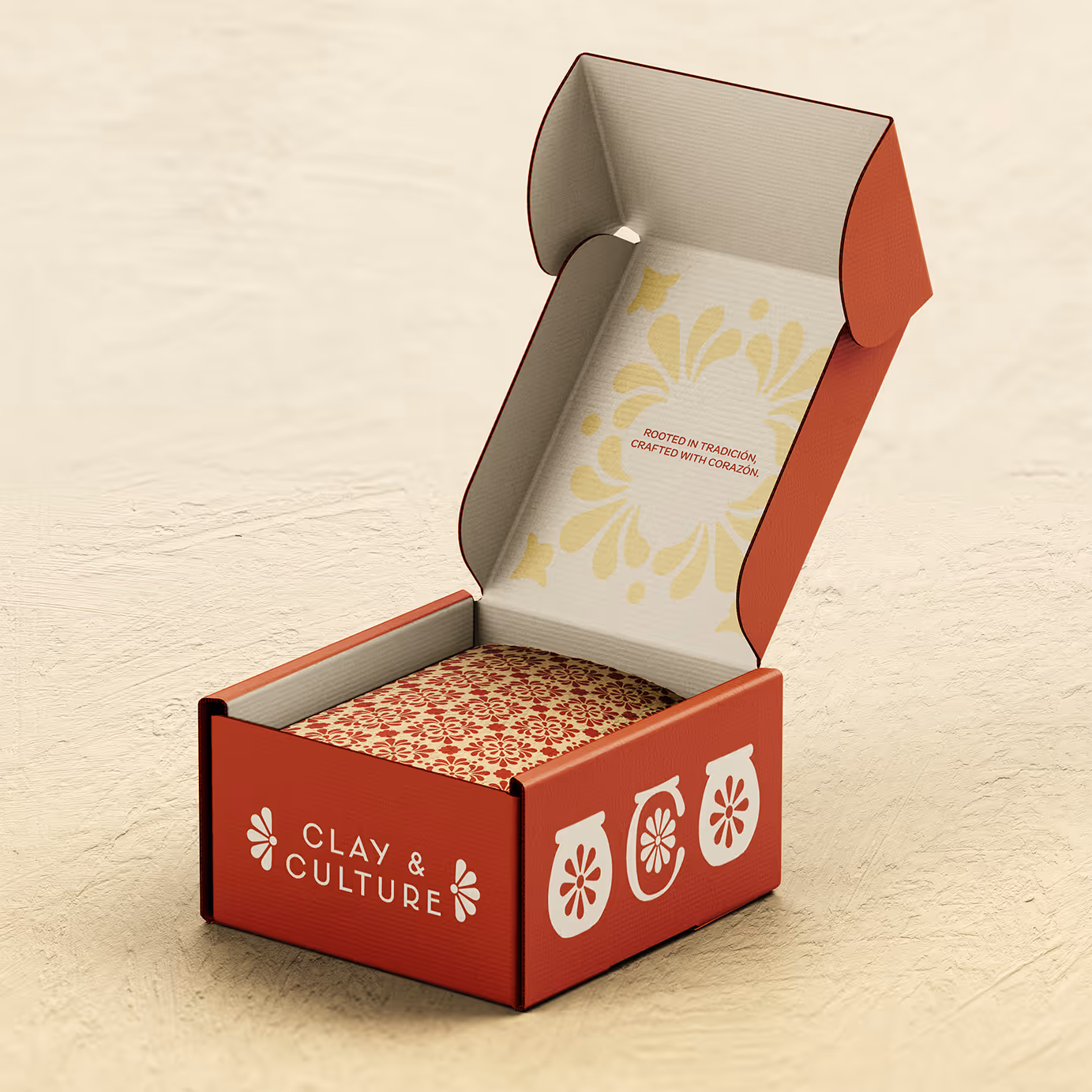 Open red box with floral pattern inside, text Clay & Culture, and crafted with corazón message.