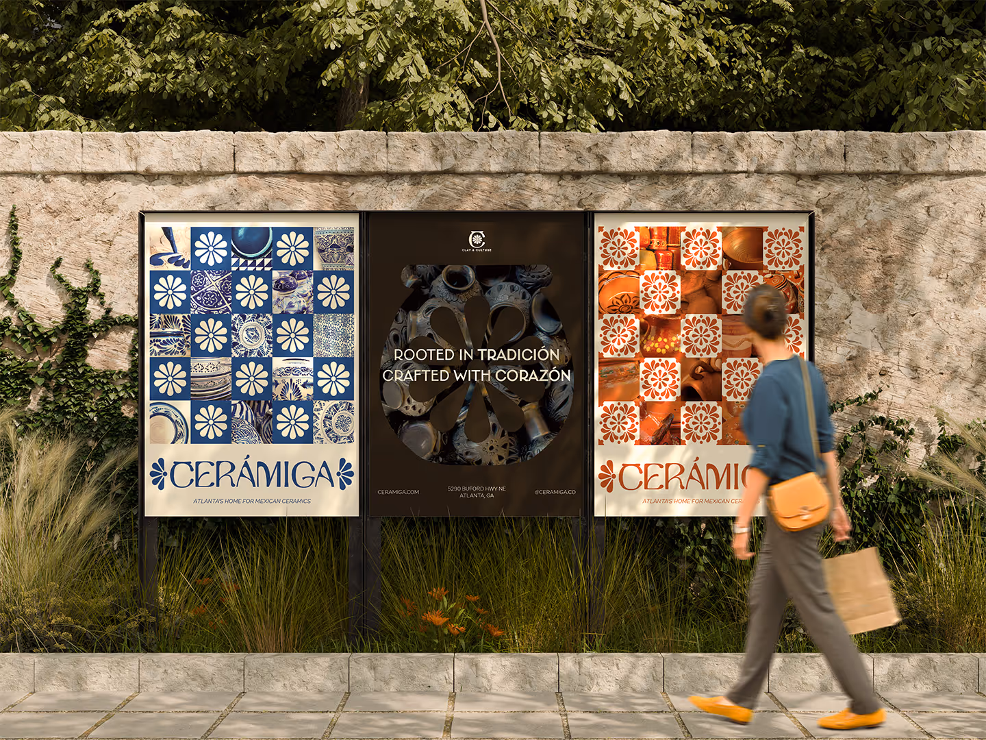 Three outdoor posters on a sidewalk showing blue, orange, and black Mexican ceramic tile patterns and pottery.