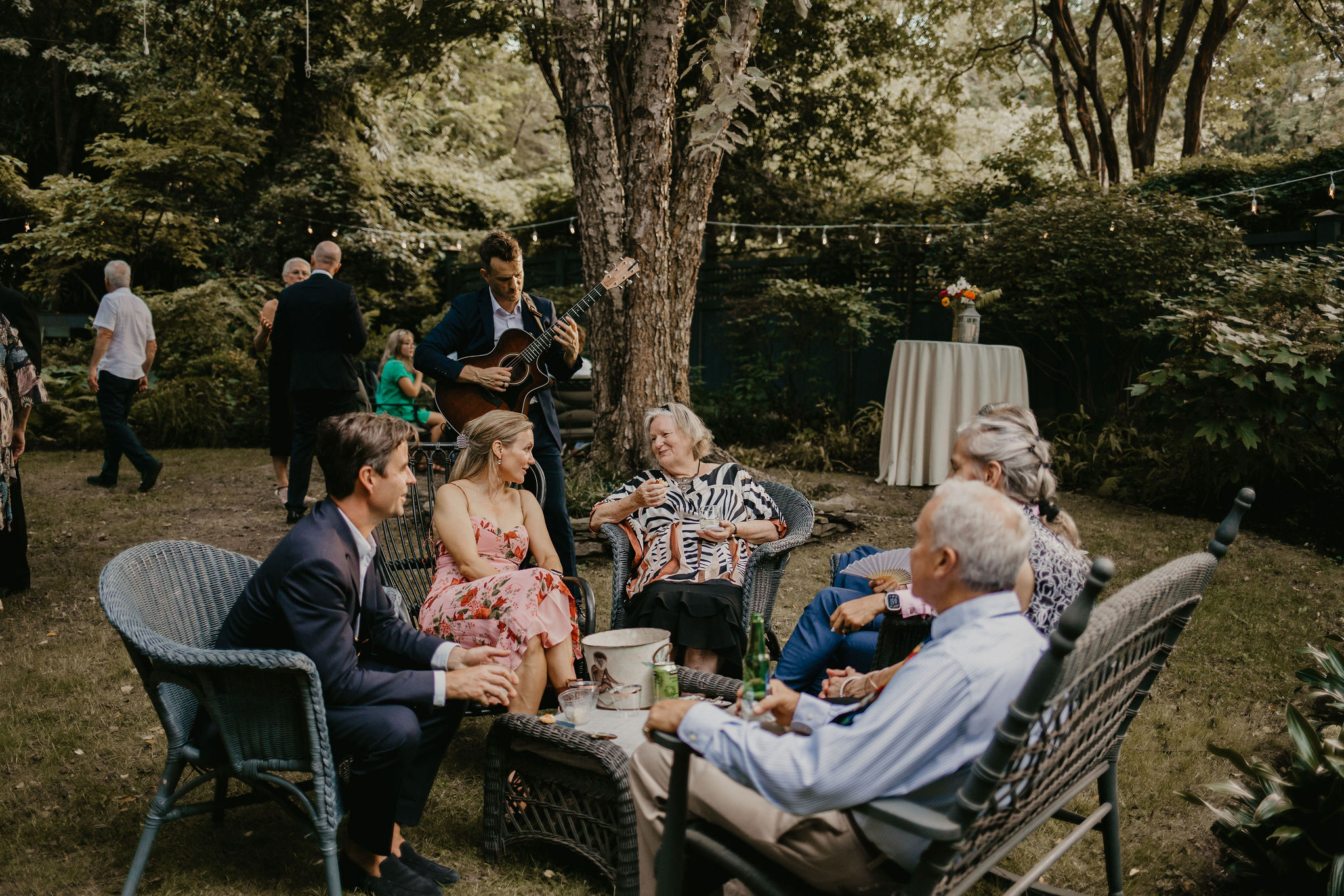 Dylan Galvin performing live wedding music for seated guests at an outdoor DMV celebration