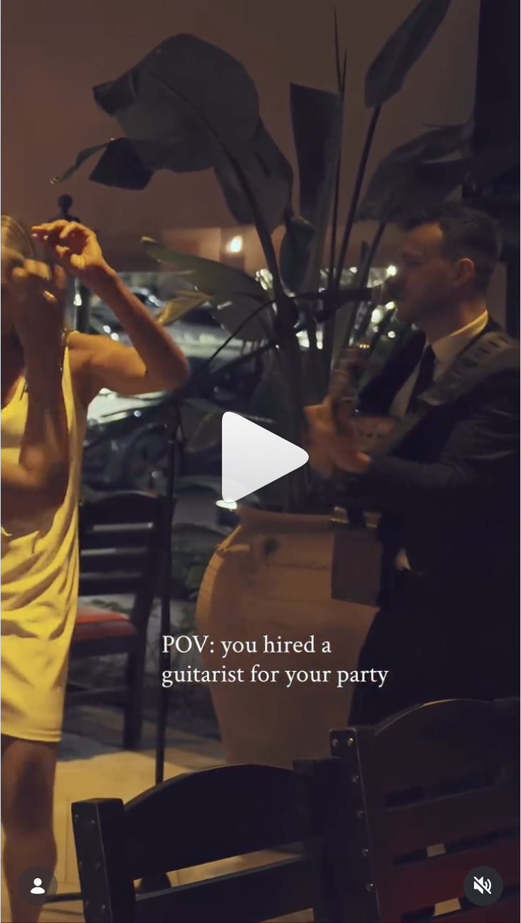 Real event footage, clip 3, guitarist performing at an evening party