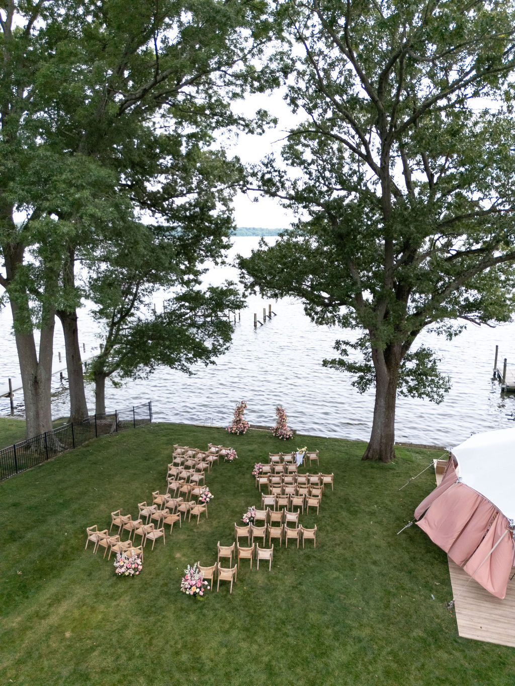 Aerial view of the ceremony lawn set up with rows of chairs and floral arrangements overlooking the Potomac River in Lorton, Virginia.