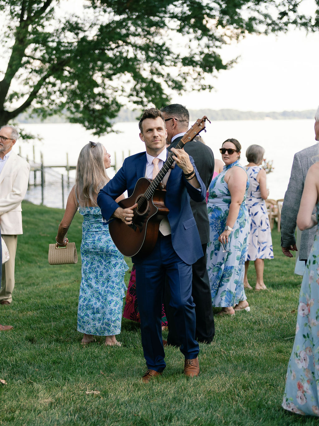 Dylan Galvin performing solo acoustic guitar on the lawn during cocktail hour at a Lorton, Virginia wedding.