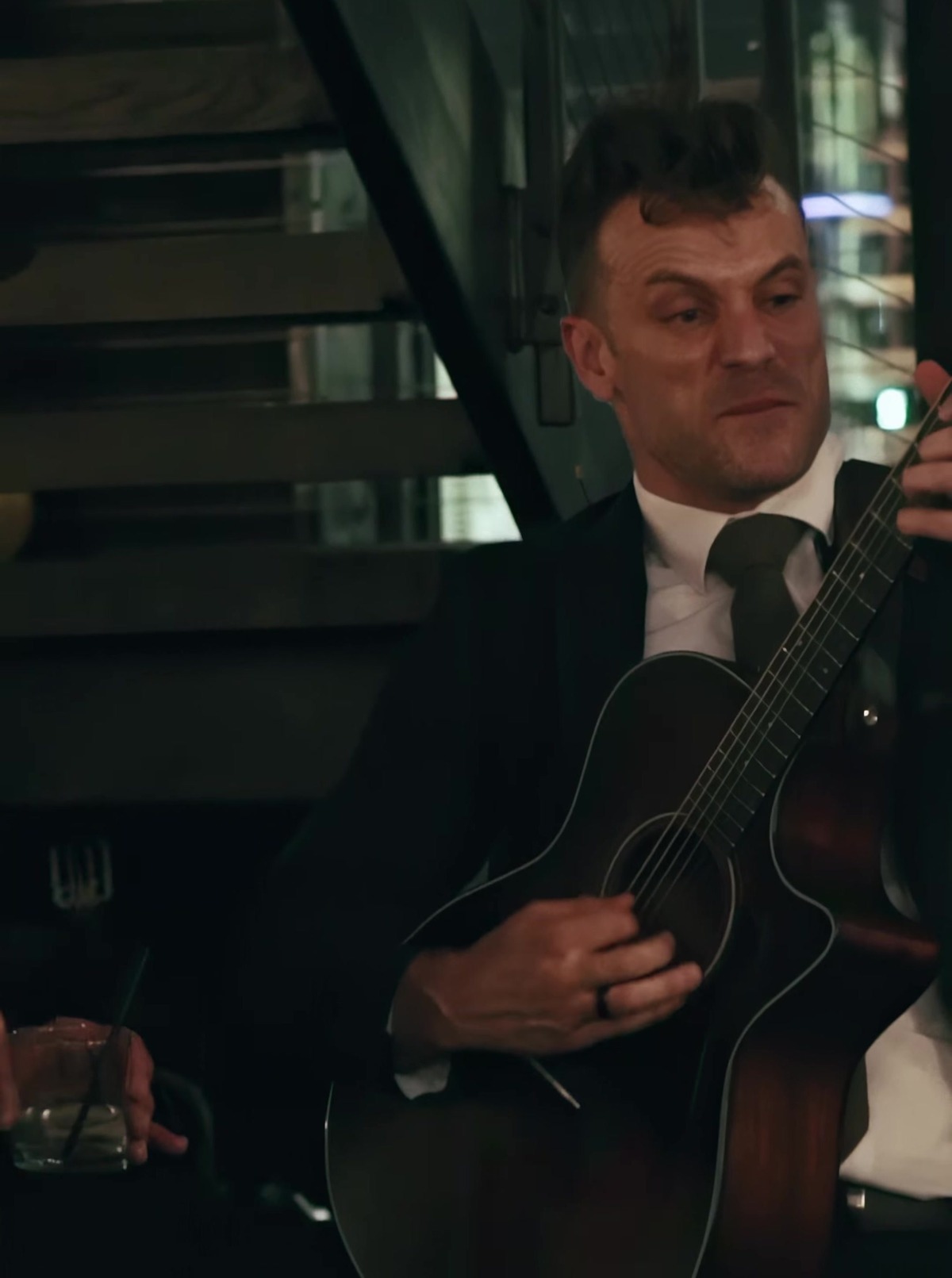 Dylan Galvin performing live guitar near the staircase at a corporate event at Blackwall Hitch, Baltimore, Maryland.