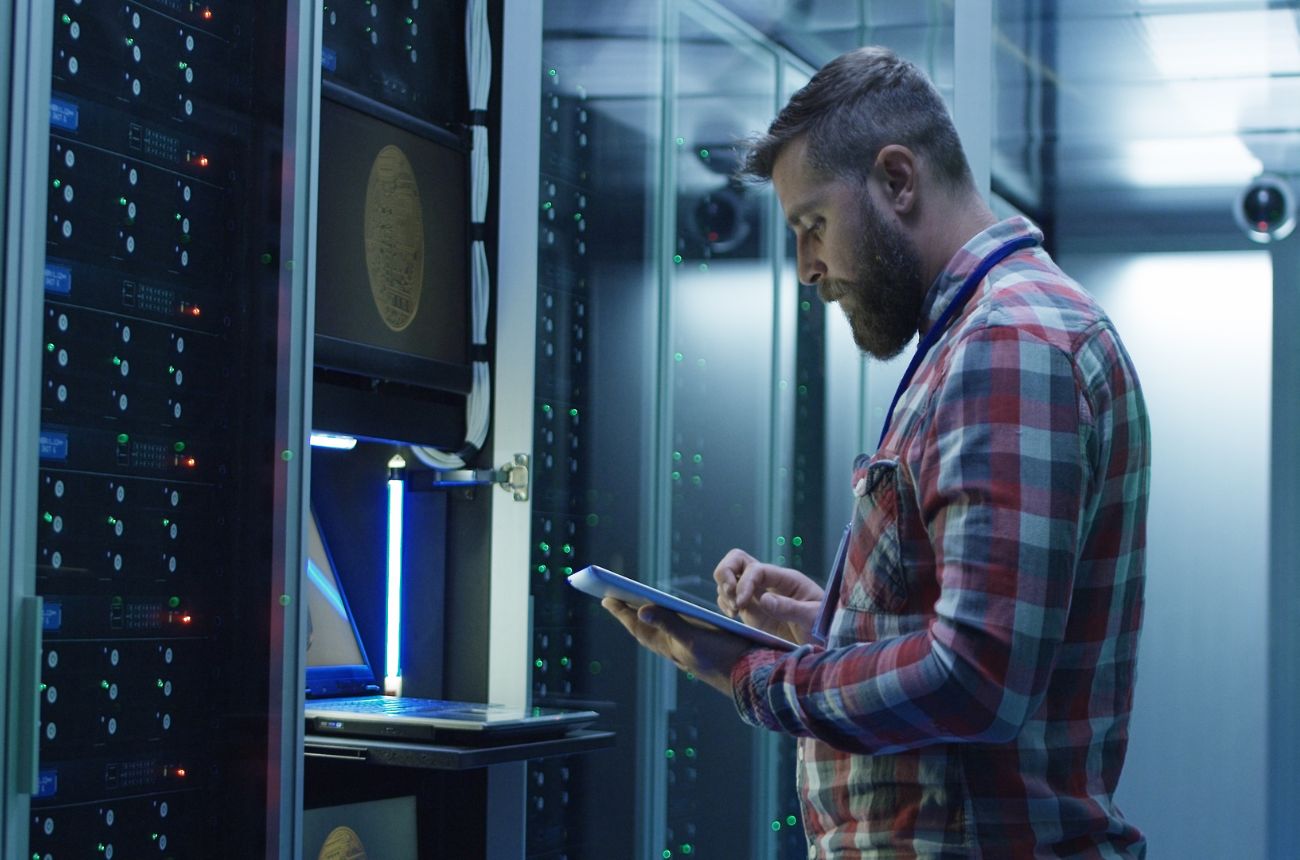 Trabajador midiendo la potencia de servidores en un centro de datos