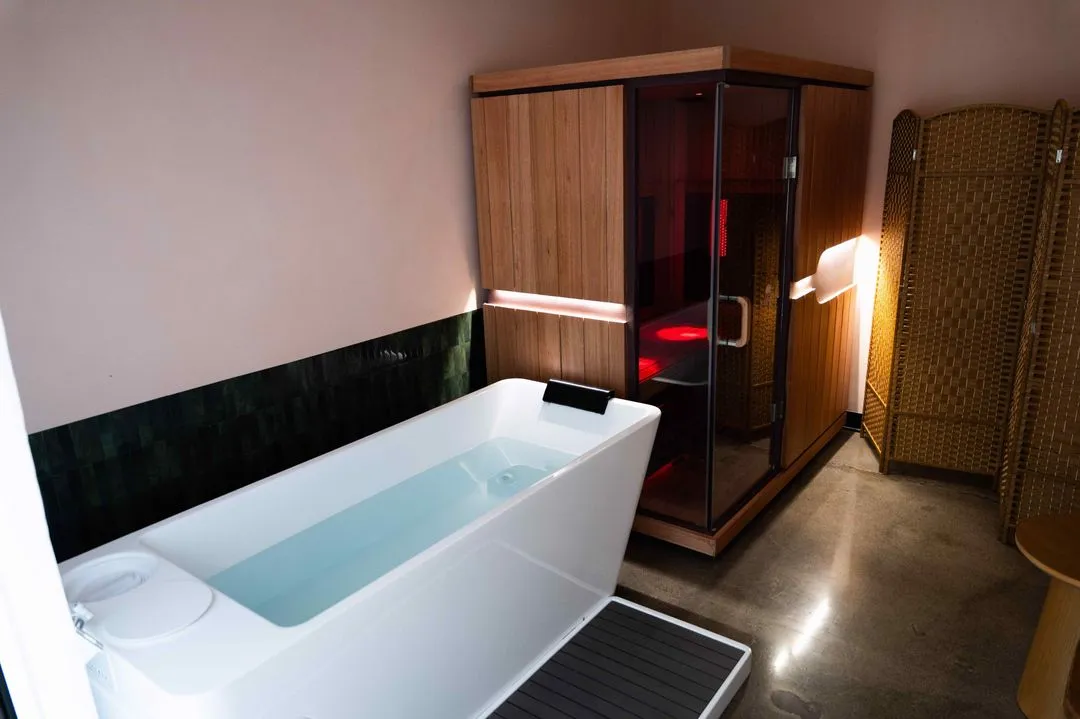 Ark Fit recovery room with an infrared sauna and a cold plunge tub side by side