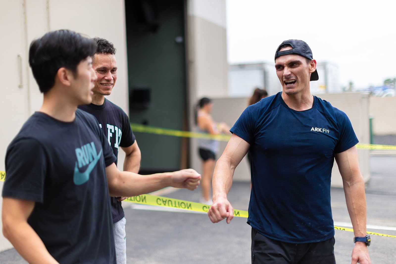 Athletes trading fist bumps at the finish of the Ark Fit HYROX half simulation