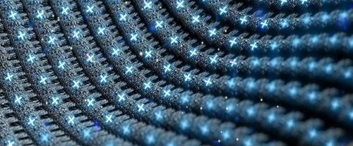 Close-up of a fabric with embedded blue LED lights forming a pattern, highlighting advanced textile technology and innovation.