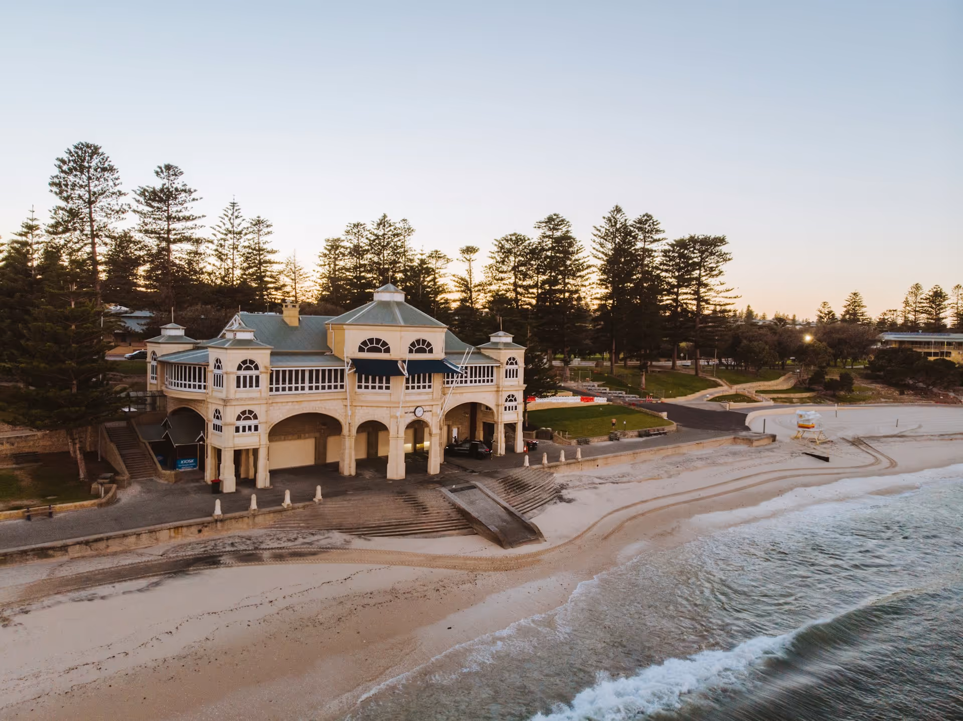 Cottesloe Beach with the Indiana Tea House building and pine trees in the background.