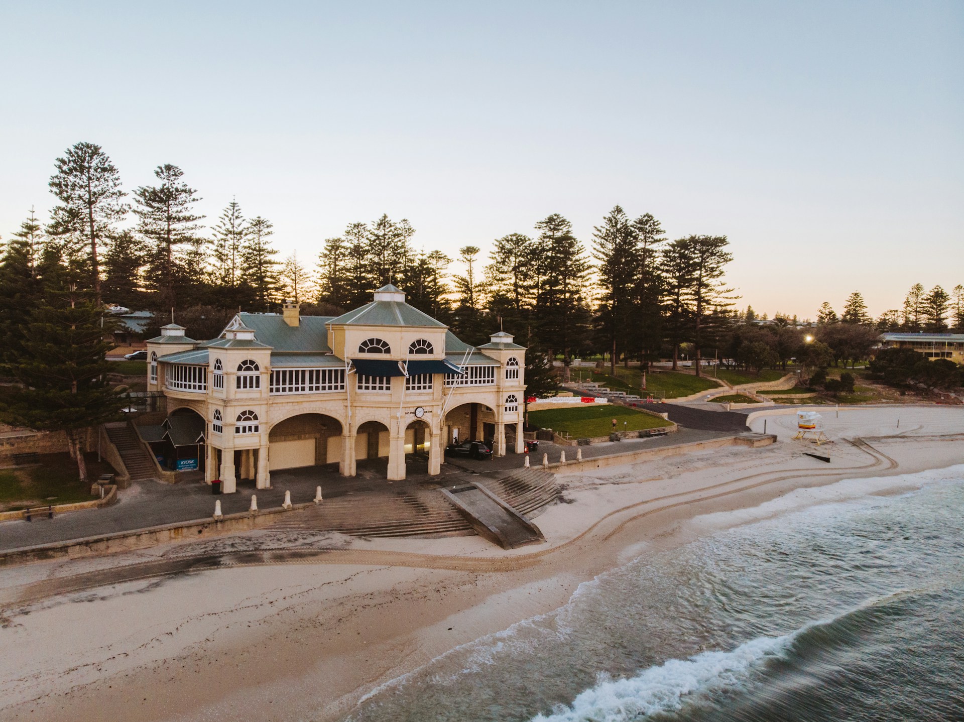 Cottesloe Beach with the Indiana Tea House building and pine trees in the background.