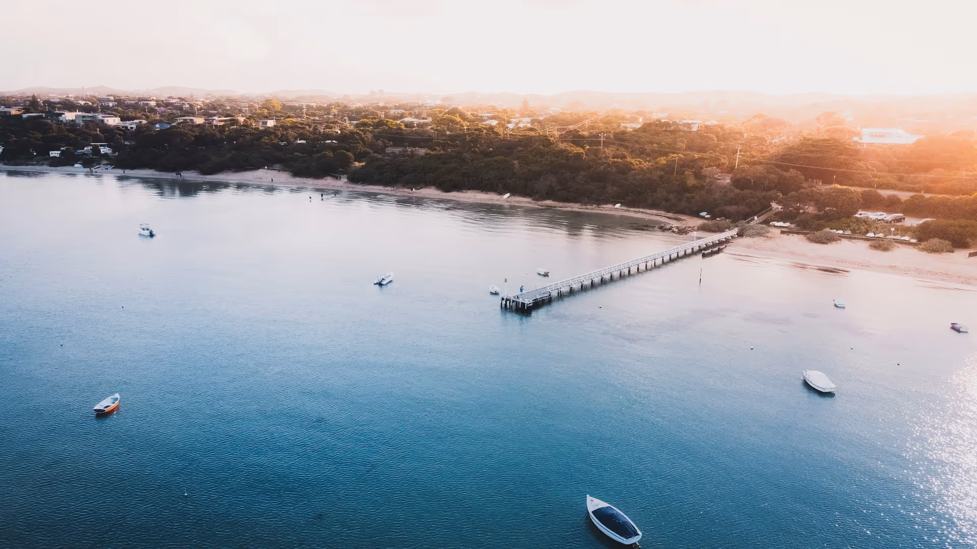 Aerial view of Blairgowrie on the Mornington Peninsula with a jetty extending into calm waters.
