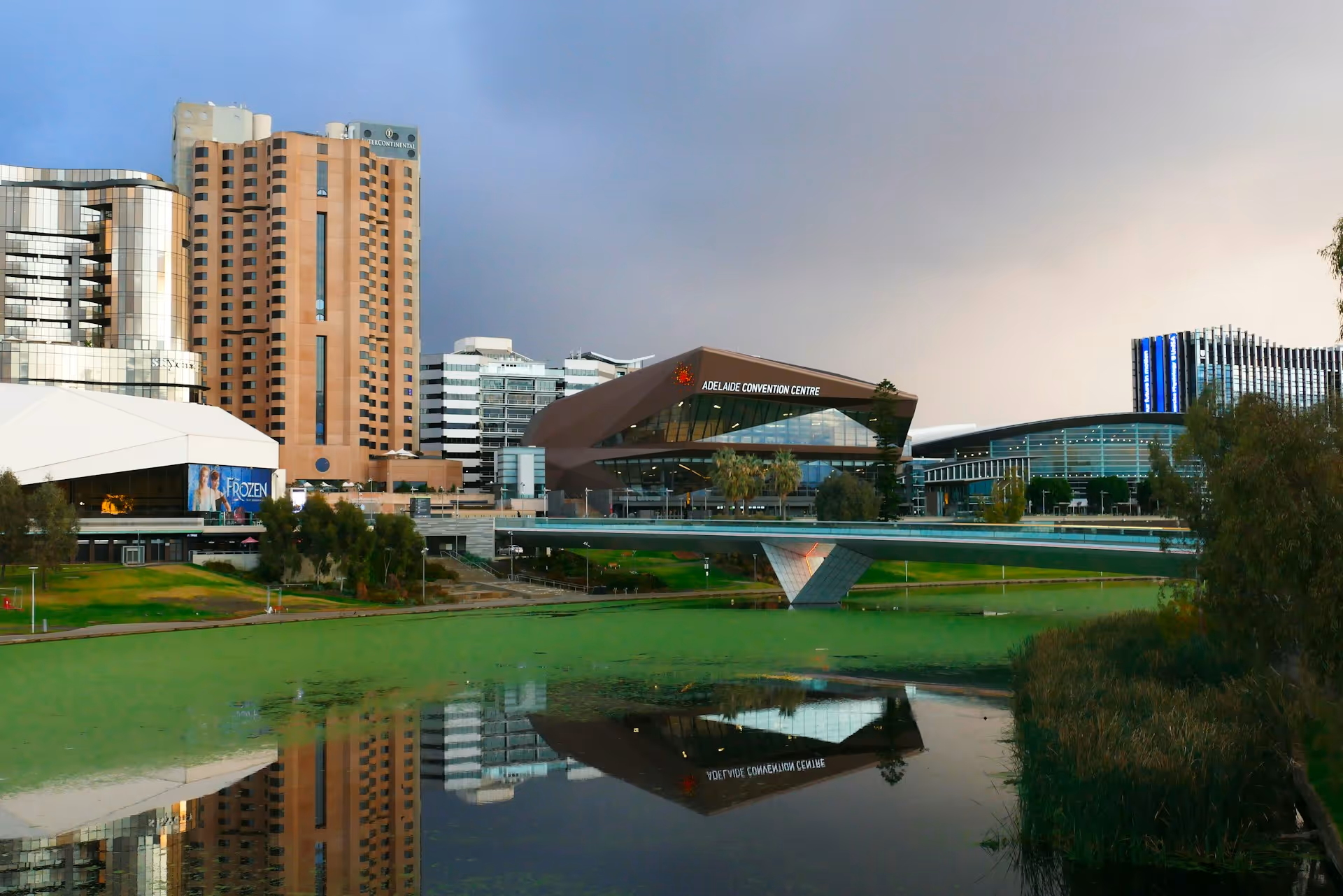 Adelaide Convention Centre and surrounding city buildings reflected in the River Torrens.