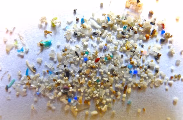 A close-up image of microplastics, showing various small particles in different shapes, sizes, and colours.