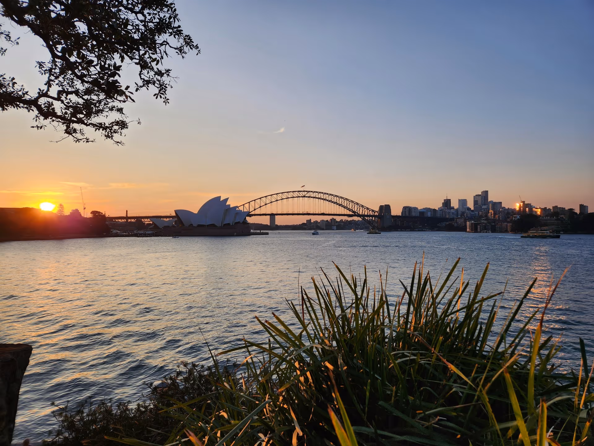 A stunning sunset view of the Sydney Opera House and Harbour Bridge from Mrs Macquarie's Chair.