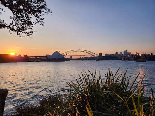 A stunning sunset view of the Sydney Opera House and Harbour Bridge from Mrs Macquarie's Chair.